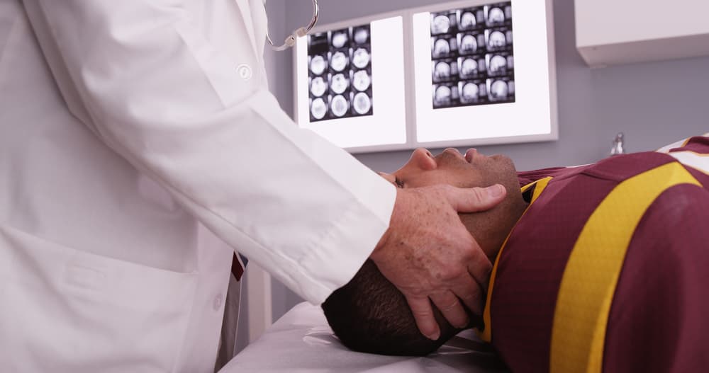 Portrait of a senior doctor consulting with a sports athlete about a brain injury.






